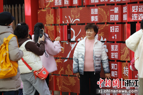 游人在祈福墻前合影。中新社發(fā)西溪濕地供圖